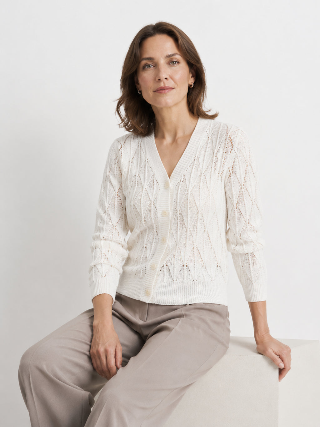 MY021 white openwork v-neck three-quarter sleeve cardigan seated model view