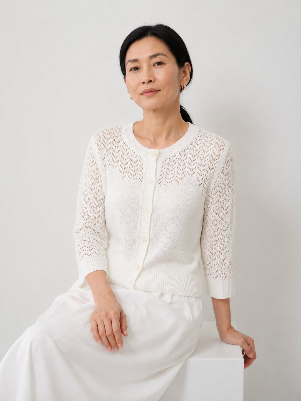 MY023 white openwork round-neck three-quarter sleeve cardigan seated model view