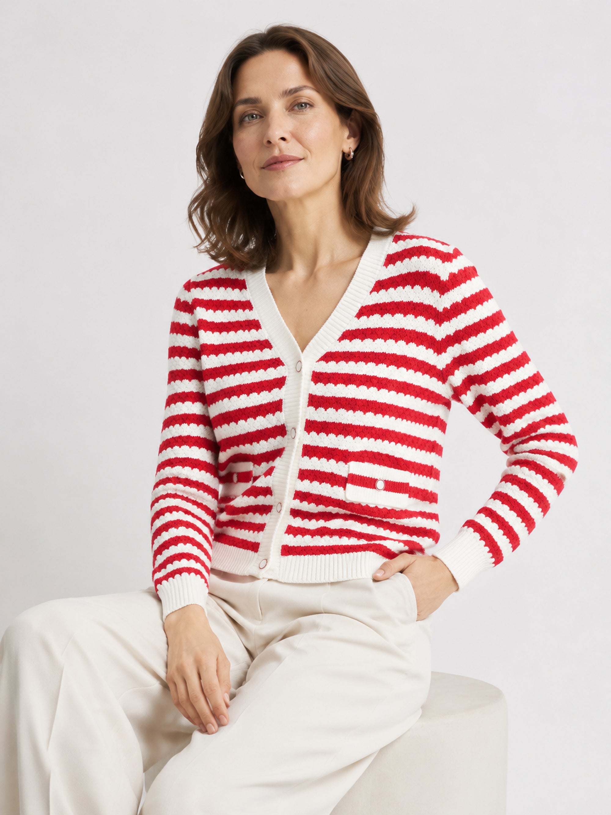 MY009 red cropped textured knit cardigan seated model view